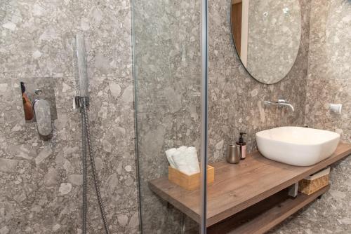 a bathroom with a sink and a shower at Kaiser Luxury Suites in Achílleion