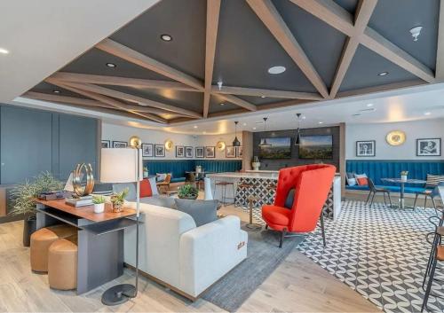 a living room with a couch and a table at Luxurious Hollywood Home City View - Free Parking 10mins to Universal Studios in Los Angeles