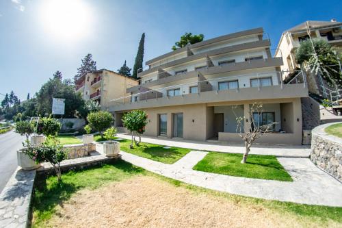 a large building with trees in front of it at Kaiser Luxury Suites in Achílleion