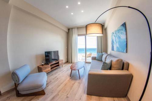 a living room with a couch and a chair at Kaiser Luxury Suites in Achílleion