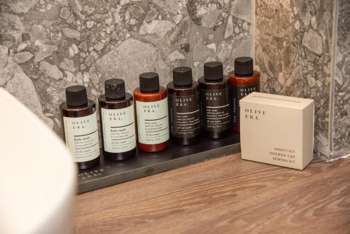 a shelf with four bottles of ink next to a box at Kaiser Luxury Suites in Achílleion