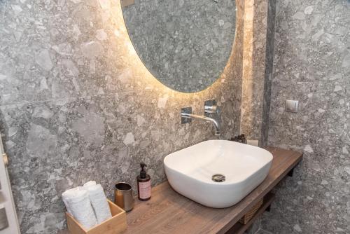 a bathroom with a sink and a mirror at Kaiser Luxury Suites in Achílleion