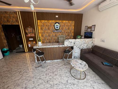 a living room with a couch and a bar at Hotel Hanuman Palace-450 meter Khatu Shayam Ji Temple in Khātu