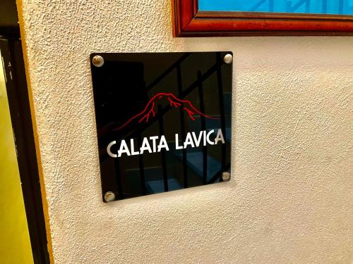 a sign on a wall that says cala la lambda at Eruption1669 in Catania