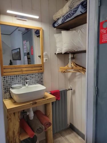 a bathroom with a sink and a mirror at Auberge La Bergerie in Sainte-Marie-de-Campan