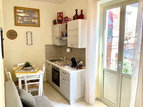 a small kitchen with a counter and a table at Eruption1669 in Catania