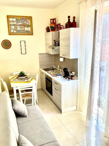 a kitchen with a couch and a table in a room at Eruption1669 in Catania