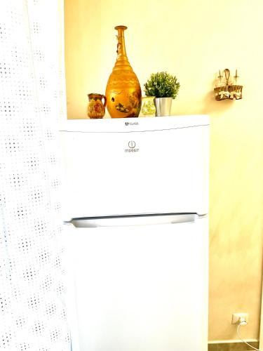 a white shelf with a vase on top of it at Eruption1669 in Catania