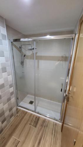 a shower stall with a glass door in a bathroom at Apartamento Torremar M in El Borseral