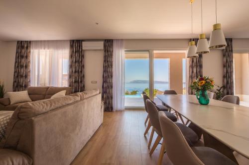a living room with a long table and a couch at Villa Filia in Tučepi