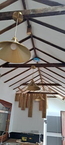 two lights hanging from a ceiling in a room at Willow's Cottage in Edwinstowe