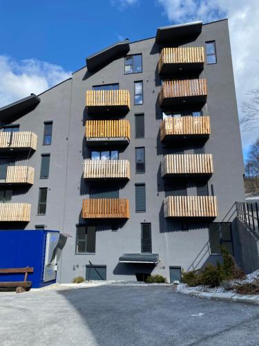 a building with wooden balconies on the side of it at Green Escape Mavrovo in Mavrovo