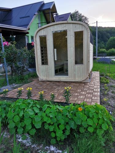 a building that is sitting on a wooden deck at Zeleni raj in Hreljin Ogulinski