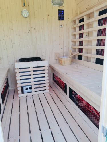 a sauna with a bench and a stove in it at Zeleni raj in Hreljin Ogulinski