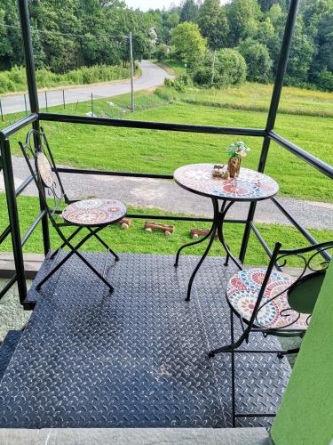 a table and two chairs on a balcony at Zeleni raj in Hreljin Ogulinski