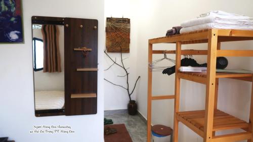 a room with a bunk bed and a mirror at Người Măng Đen Homestay in Kon Von Kla