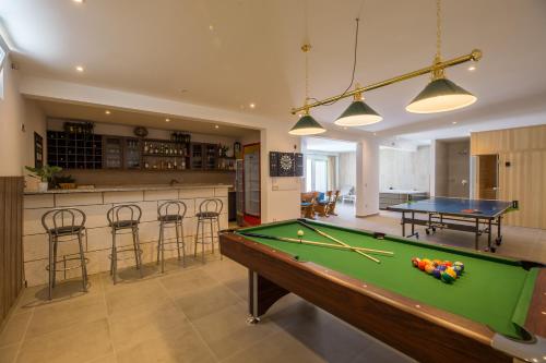 a living room with a pool table and a bar at Villa Filia in Tučepi