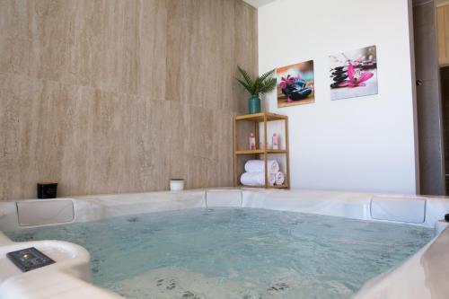 a jacuzzi tub in the middle of a room at Villa Filia in Tučepi