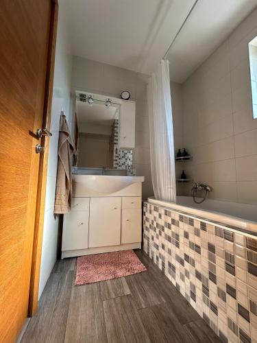 a bathroom with a sink and a mirror at Apartman Gaby in Virovitica