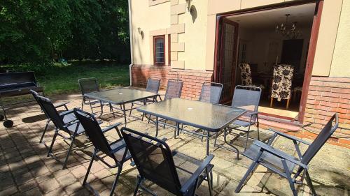 a patio with tables and chairs and a piano at Spacious Home for Large Families and Contractors in Wolverhampton