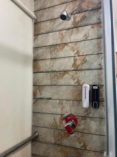 a shower with a stone wall in a bathroom at Hotel Seth Murlidhar Seva Sadan-Near Prem Mandir in Vrindāvan