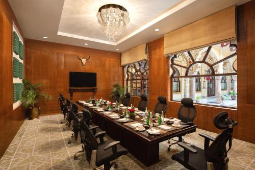 a large conference room with a long table and chairs at Noormahal Palace Hotel in Karnāl