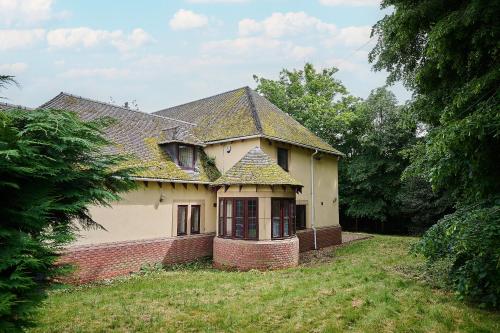 an old house in a field with trees at Spacious Home for Large Families and Contractors in Wolverhampton