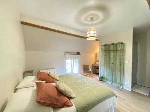 a bedroom with a large bed with pillows on it at La mise en Seine in Venables
