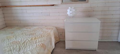 a bedroom with a bed and a dresser with a balloon at Suvikoti in Lokalahti