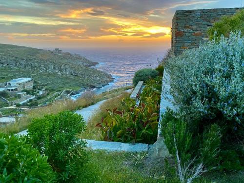 a bench sitting on a hill next to the ocean at Afrodite five in Koundouros