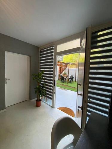 a room with a sliding glass door with a plant at Sea Urban 4 Varkiza in Vari