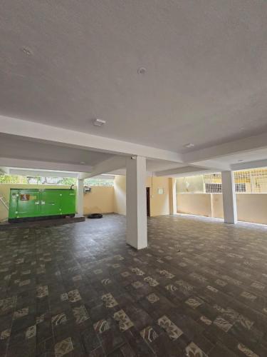 a large empty room with a green object in it at Nandan Enclave in Mysore