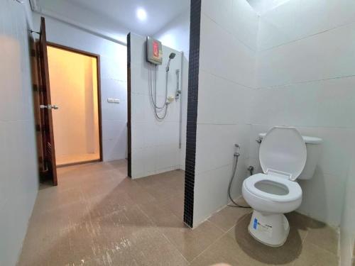 a bathroom with a white toilet and a shower at Banchang home village in Ban Phayun