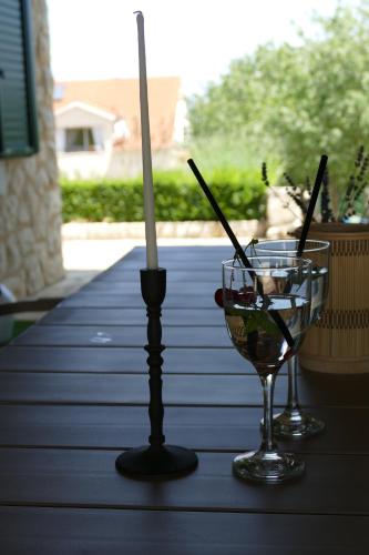 a candle and a wine glass on a table at Kalpic Suites & Villa in Lozovac