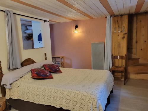a bedroom with a bed with two pillows on it at Auberge La Bergerie in Sainte-Marie-de-Campan