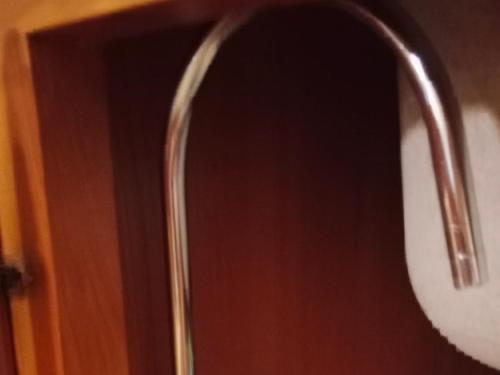 a mirror on a wooden door with a handle at Via della musica in Vicchio