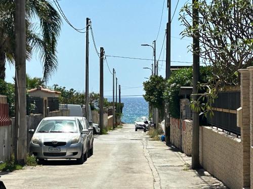a car parked on a street next to the ocean at Villa Sole near the sandy beach, parking & wifi in Avola