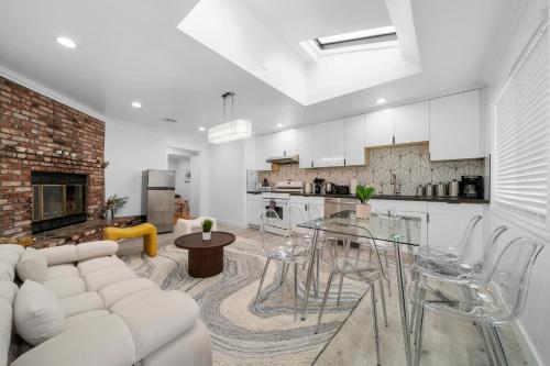 a living room with a white couch and a table at # Marbella Lane - Serene and Pristine 2BR Home in West Covina