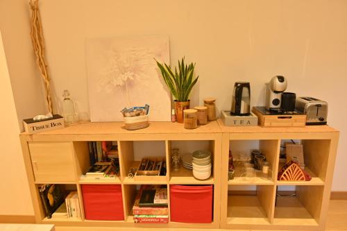 a wooden book shelf with items on it at Nature Nest in Pontivy