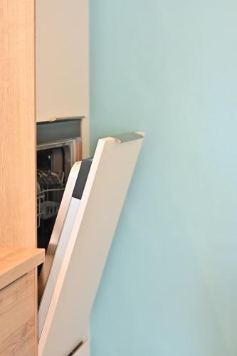 an open drawer in a kitchen with a refrigerator at Nature Nest in Pontivy