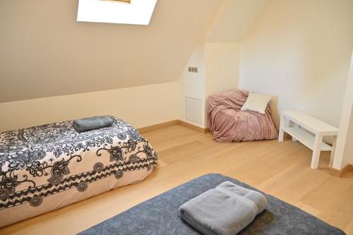 a room with a bed and a table and a desk at Nature Nest in Pontivy
