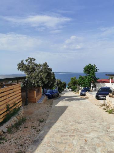 a street with cars parked on the side of the road at Mobile Home Happy Family Šimuni in Šimuni