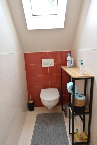 a bathroom with a toilet and a skylight at Nature Nest in Pontivy