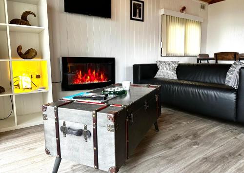 a living room with a couch and a fireplace at Lodge Cabin with Fabulous Views - Farm Holiday in Stranraer