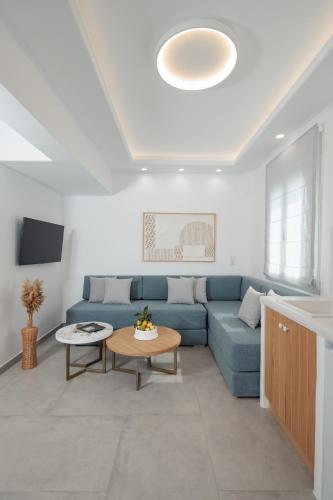 a living room with a blue couch and a table at Agia Anna Living in Agia Anna Naxos