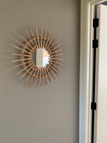 a mirror hanging on a wall in a room at Durbuy Dream in Durbuy