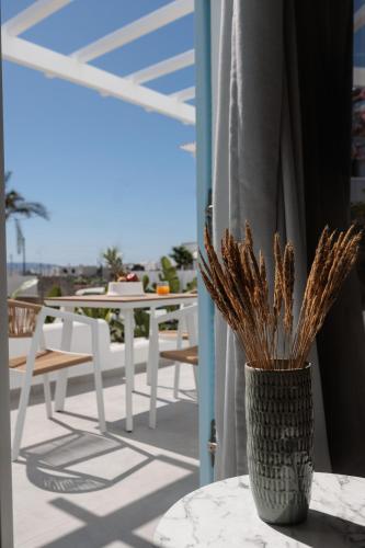 a vase sitting on a table on a balcony at Agia Anna Living in Agia Anna Naxos