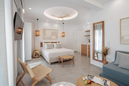 a bedroom with a bed and a couch and a table at Agia Anna Living in Agia Anna Naxos