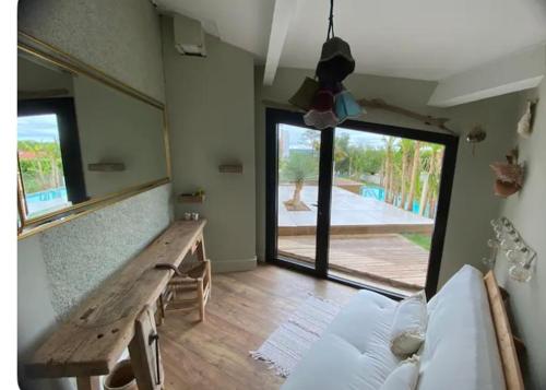 a living room with a wooden table and a bench at Le Zingaro in Busque
