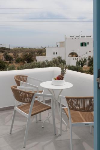 a white table and chairs on a balcony at Agia Anna Living in Agia Anna Naxos
